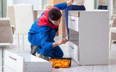 Contractor repairman assembling furniture under woman supervisio